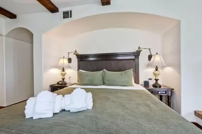 a bedroom with a large bed with two lamps at 7323 Estrella Del Mar Unit 6537 in Carlsbad