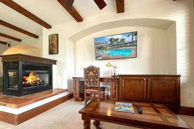 a living room with a fireplace and a table at 7323 Estrella Del Mar Unit 6537 in Carlsbad