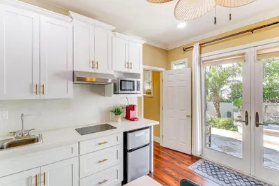 a kitchen with white cabinets and a sink and a window at 9 Mi to Beach Pet-Friendly Apt in San Diego! in San Diego