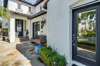 a front door of a house with a bench at 9 Mi to Beach Pet-Friendly Apt in San Diego! in San Diego