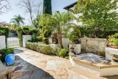 a garden with potted plants and a fence at 9 Mi to Beach Pet-Friendly Apt in San Diego! in San Diego
