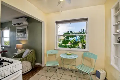 a kitchen with a window and a table and chairs at 165 n 167 Tamarack in Carlsbad