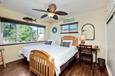 a bedroom with a bed and a ceiling fan at 5285 Shore Drive in Carlsbad