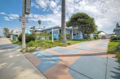 a street sign on a sidewalk in front of houses at 167 Tamarack in Carlsbad