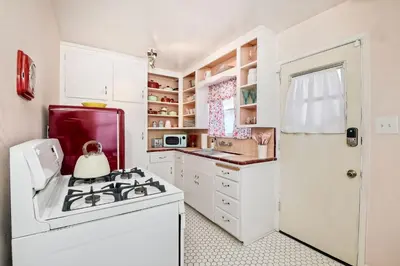 a kitchen with a white stove and a red refrigerator at 165 Tamarack in Carlsbad