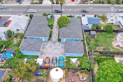 an overhead view of roofs of houses with parked cars at 165 Tamarack in Carlsbad