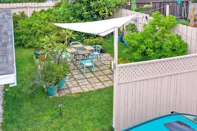 a backyard with a table and a white umbrella at 165 Tamarack in Carlsbad