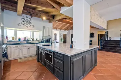 an open kitchen with a large center island with granite counter tops at 5194 Carlsbad Lower in Carlsbad