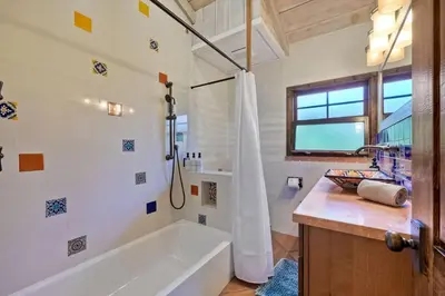 a bathroom with a tub and a sink at 5194 Carlsbad Lower in Carlsbad