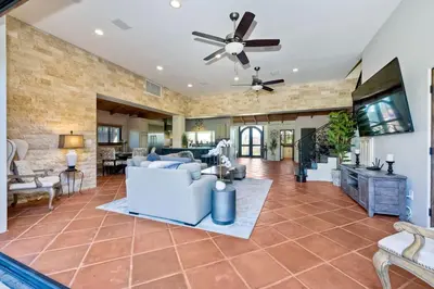 a living room with a white couch and a ceiling fan at 5194 Carlsbad Lower in Carlsbad
