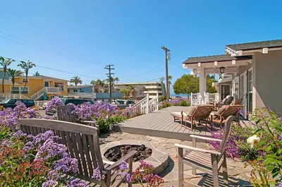 a patio with chairs and flowers on a house at 190 Walnut in Carlsbad