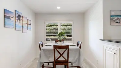 a dining room with a table and a window at Walk to Beach Pool Hot Tub Private Patio Parking Seabreeze Retreat in Dana Point