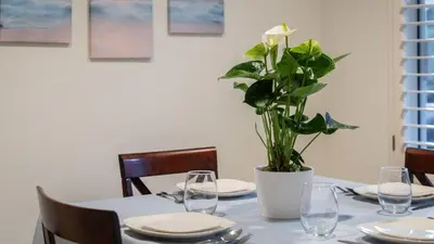 a table with a vase with a plant on it at Walk to Beach Pool Hot Tub Private Patio Parking Seabreeze Retreat in Dana Point