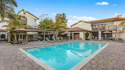 a swimming pool in front of a house at Walk to Beach Pool Hot Tub Private Patio Parking Seabreeze Retreat in Dana Point