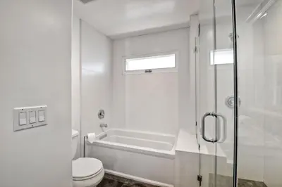 a bathroom with a tub and a toilet and a shower at 3636 Carlsbad Blvd - Lower in Carlsbad