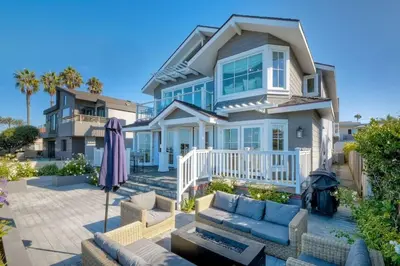 a house with a patio with a couch and an umbrella at 3636 Carlsbad Blvd - Lower in Carlsbad