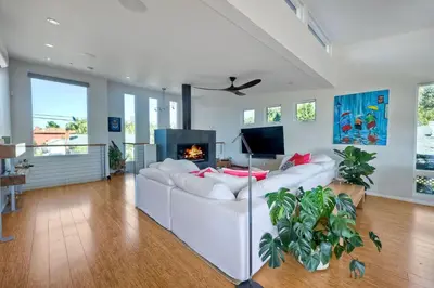 a living room with a white couch and a fireplace at 253 E Jason Street in Encinitas