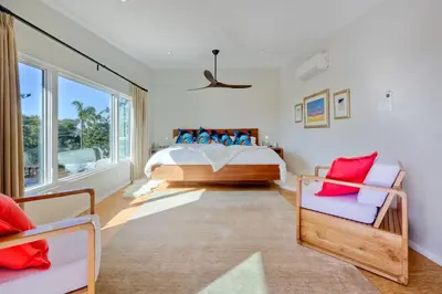 a bedroom with a bed and two chairs at 253 E Jason Street in Encinitas