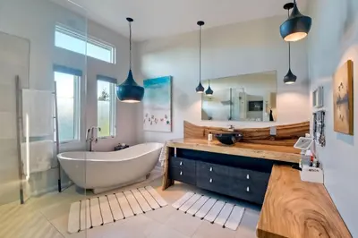 a bathroom with a tub and a large mirror at 253 E Jason Street in Encinitas