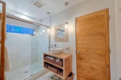 a bathroom with a sink and a glass shower at 253 E Jason Street in Encinitas