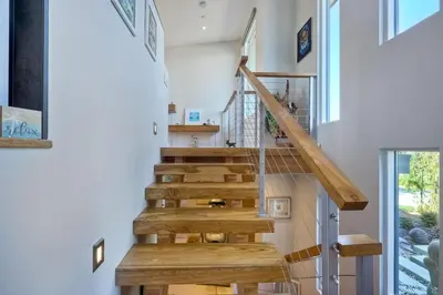 a wooden staircase in a house with a window at 253 E Jason Street in Encinitas