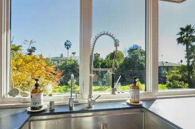 a kitchen counter with two bottles on a window ledge at 253 E Jason Street in Encinitas
