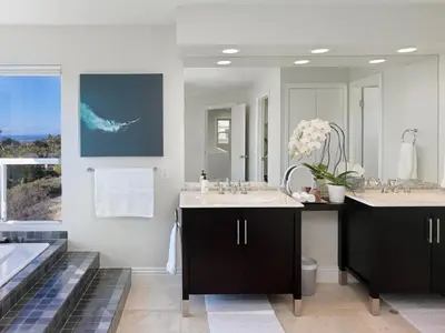 a bathroom with a sink and a large mirror at 327 Hillcrest Drive in Encinitas
