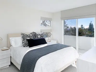 a white bedroom with a large bed and a window at 327 Hillcrest Drive in Encinitas