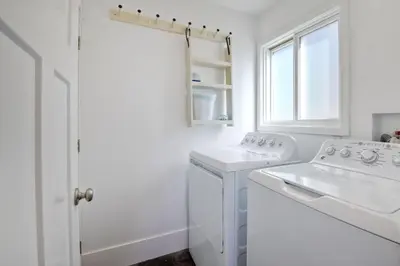 a white laundry room with a washer and dryer at 3636 Carlsbad Blvd - Entire Home in Carlsbad