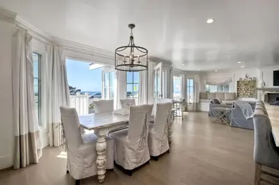 a dining room with a table and white chairs at 3636 Carlsbad Blvd - Entire Home in Carlsbad