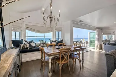 a dining room with a table and a couch at 3636 Carlsbad Blvd - Entire Home in Carlsbad