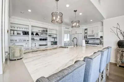 a large kitchen with white cabinets and a dining room at 3636 Carlsbad Blvd - Entire Home in Carlsbad