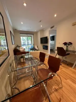 a living room with a glass table and chairs at Irvine Gem Luxury condo 31 days min near Irvine Business & UCI Hospital in Irvine