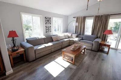 a living room with a couch and a table at Family fun near the beach-sold in Oceanside