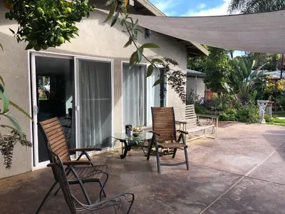 a patio with three chairs and a table and a table at Family fun near the beach-sold in Oceanside
