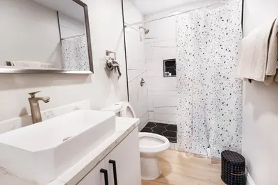 a white bathroom with a sink and a shower at Exotic home Cumberland street by sdstay in San Diego
