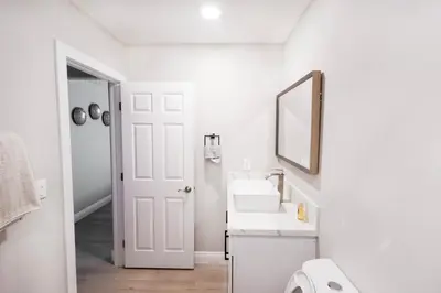 a white bathroom with a sink and a mirror at Exotic home Cumberland street by sdstay in San Diego