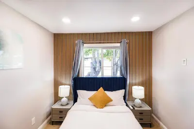 a bedroom with a bed with two night stands and a window at Exotic home Cumberland street by sdstay in San Diego