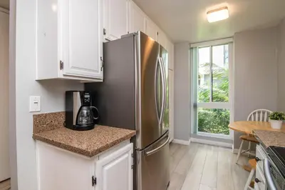 a kitchen with a stainless steel refrigerator at Walk to the Beach Balcony Sunset Ocean Views in Oceanside