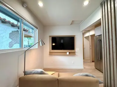 a living room with a couch and a flat screen tv at Titus Retreat in San Diego