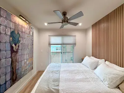 a bedroom with a bed and a ceiling fan at Titus Retreat in San Diego