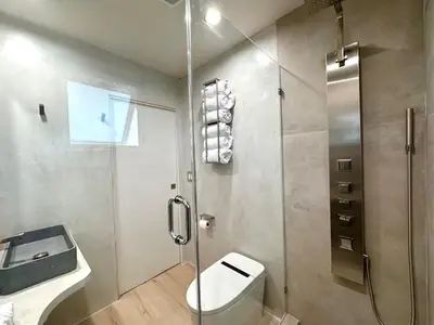 a bathroom with a shower and a toilet and a sink at Titus Retreat in San Diego