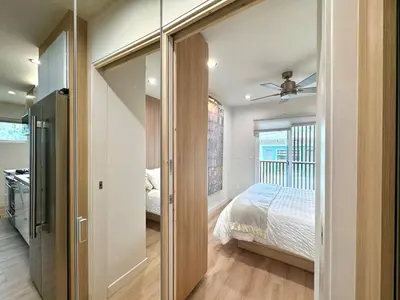 a bedroom with a bed and a sliding glass door at Titus Retreat in San Diego