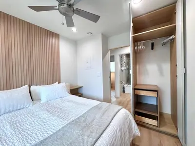 a bedroom with a bed and a ceiling fan at Titus Retreat in San Diego