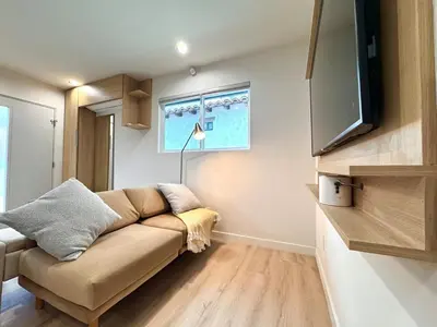 a living room with a couch and a flat screen tv at Titus Retreat in San Diego