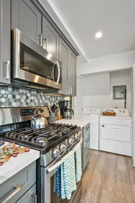 a large kitchen with a stove top oven at Steps to the Beach with Private Patio BBQ and Fire Pit in San Diego