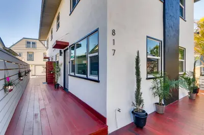 a porch of a house with potted plants on it at Steps to the Beach with Private Patio BBQ and Fire Pit in San Diego