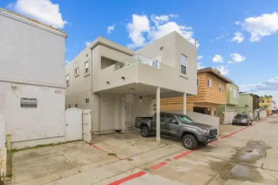 a truck parked in front of a house at Bayside Getaway Steps to the Ocean with AC Private Patio BBQ Family and Pet Friendly in San Diego