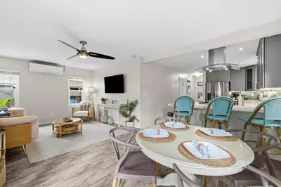 a living room and dining room with a table and chairs at Bayside Getaway Steps to the Ocean with AC Private Patio BBQ Family and Pet Friendly in San Diego