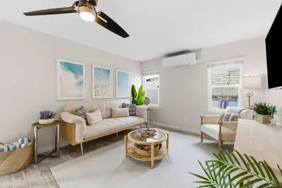 a living room with a couch and a table at Bayside Getaway Steps to the Ocean with AC Private Patio BBQ Family and Pet Friendly in San Diego